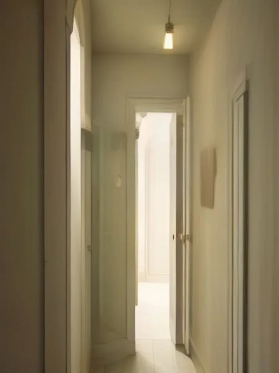 A narrow doorway of light between two soft weathered rock walls, with gentle fog passing through.